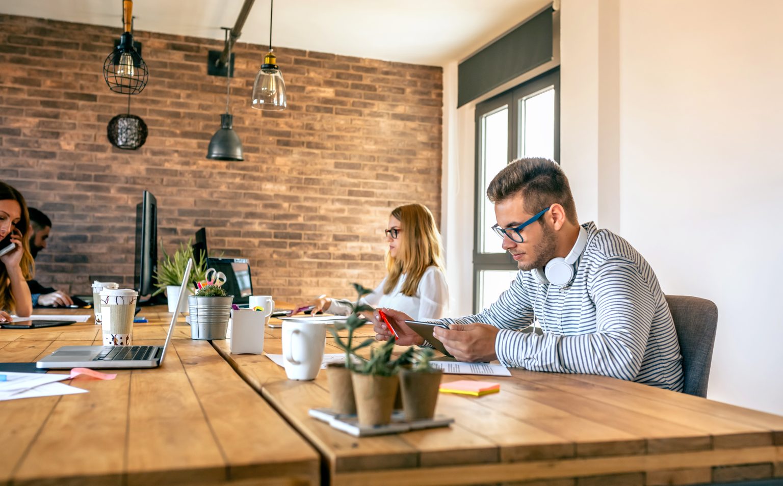 Young businessman working in a coworking office with his colleagues